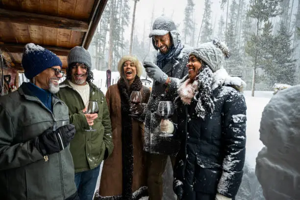 A group of friends hiking in snowy mountains during winter pause joyfully for happy christmas and new year wishes in an Adventurous Merry Christmas and Happy New Year Wishes scene.