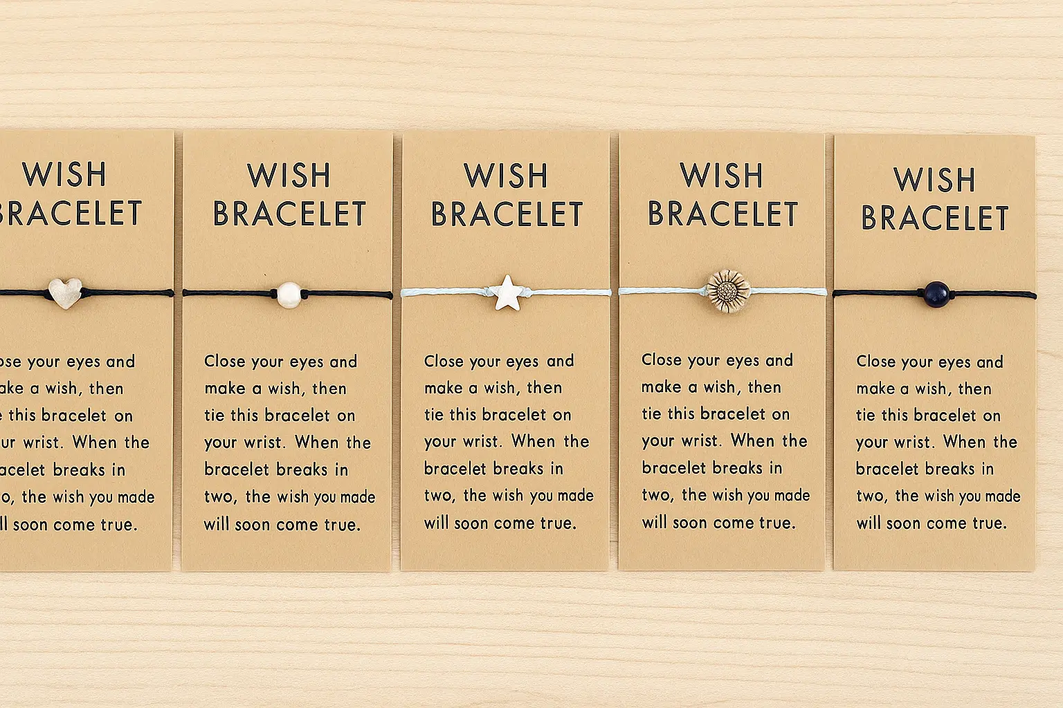 Colorful wish bracelets with small charms arranged on a kraft “Make a wish” card in soft light.