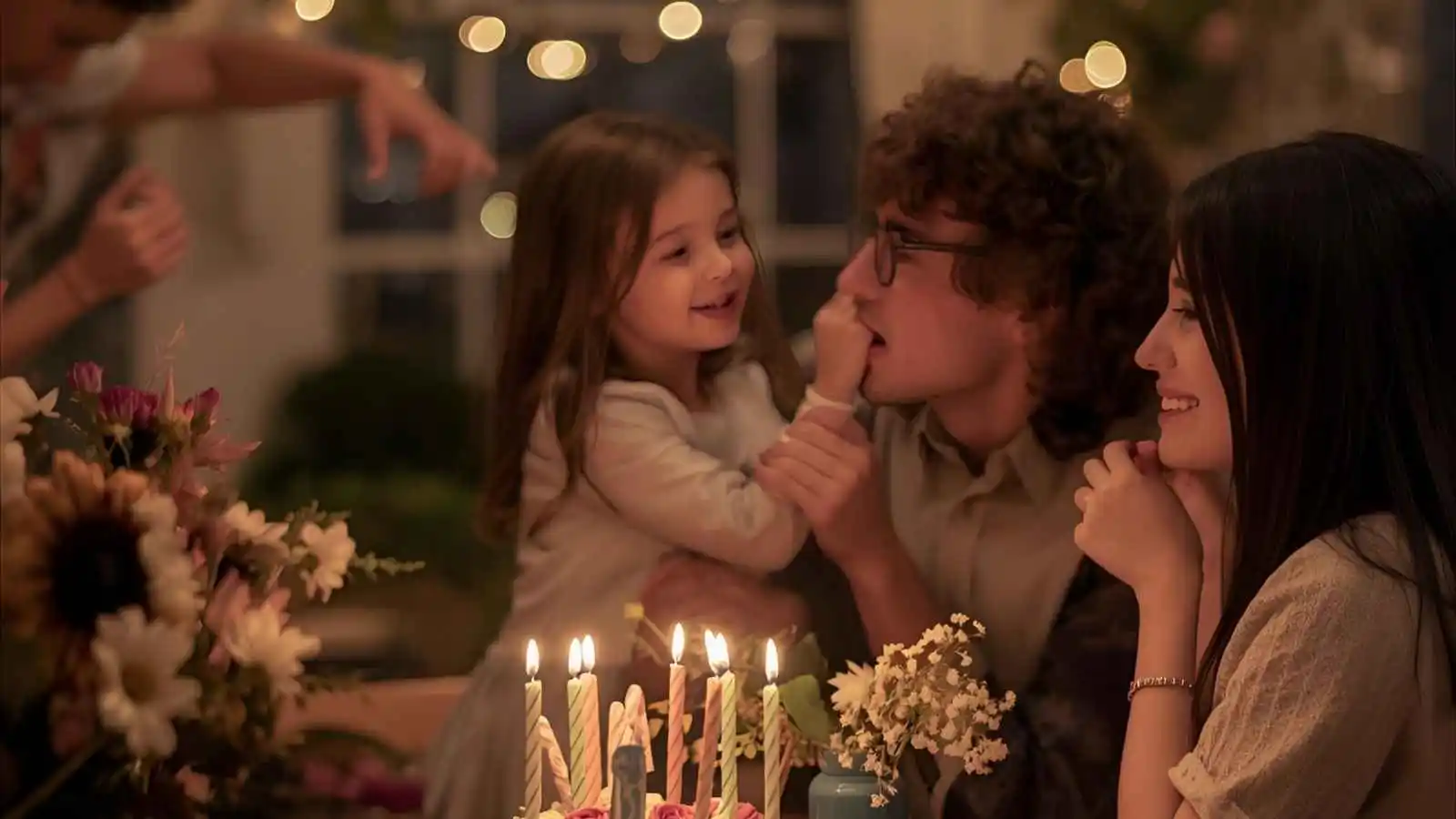 “Birthday card with flowers and cake on a table, family celebration atmosphere”