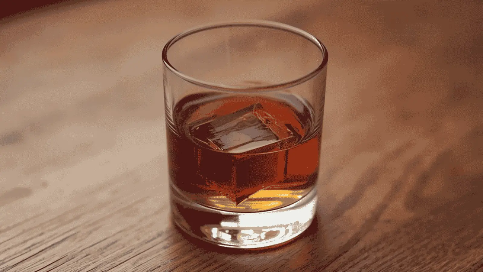 A glass of whiskey served neat, showcasing its color and clarity.