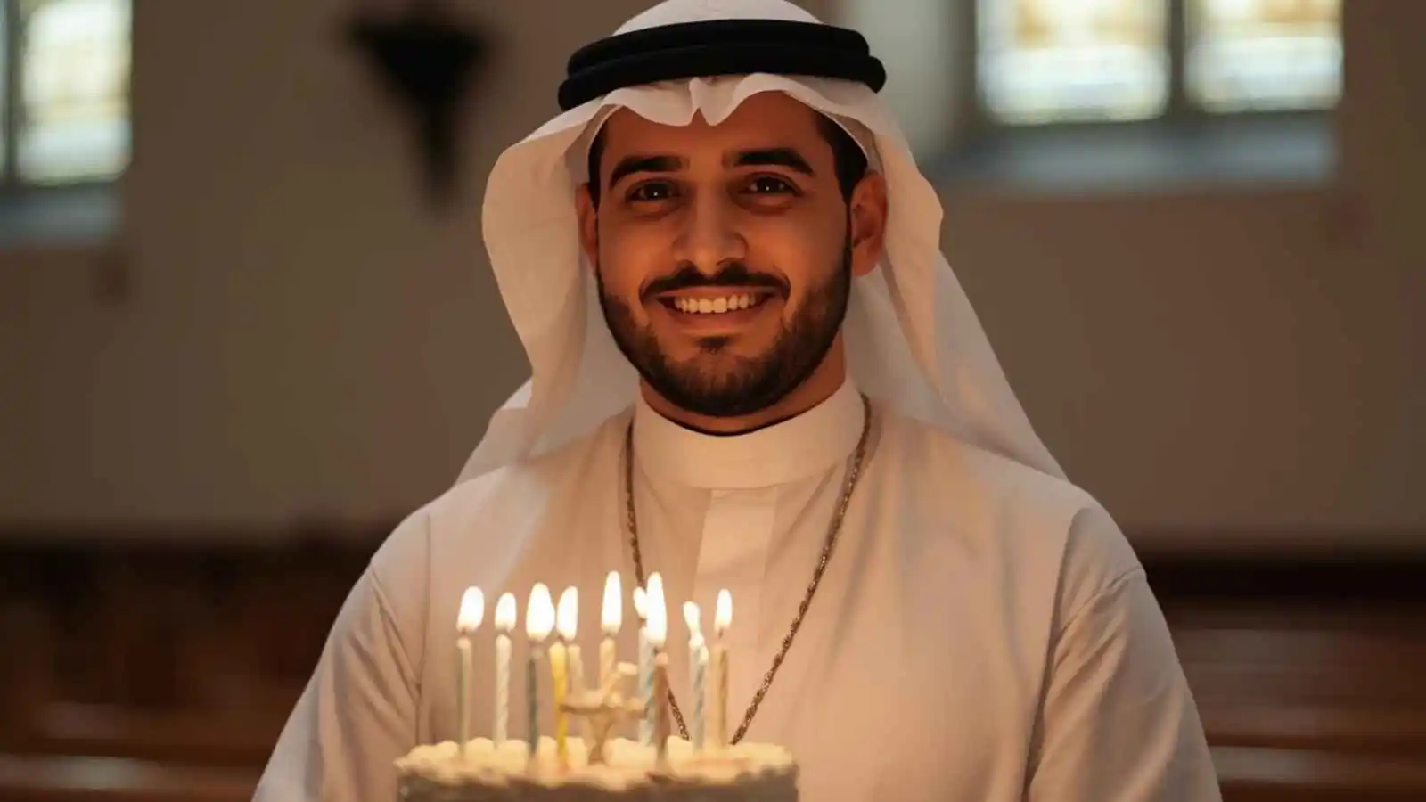 Priest celebrating birthday with cake in church, warm and joyful atmosphere